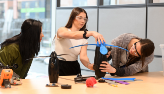 three students working on an innovation project