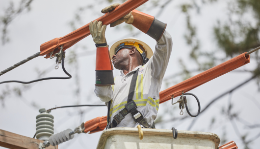 employee-wearing-safety-gear-working-on-power-line